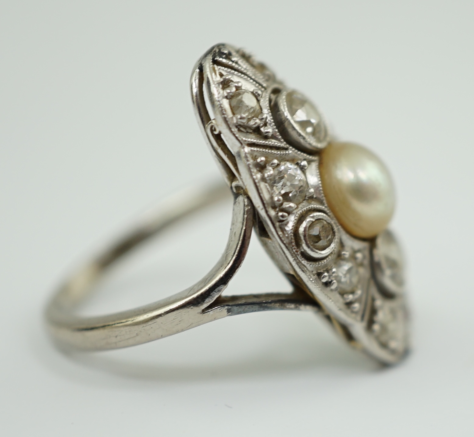 A Belle Epoque 18ct white gold, single stone split pearl and millegrain set diamond cluster lozenge shaped dress ring